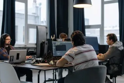 Team of developers working together on computers representing internal developer platforms