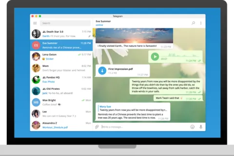 Official Telegram Desktop homepage hero capture showing the app interface inside a laptop mockup