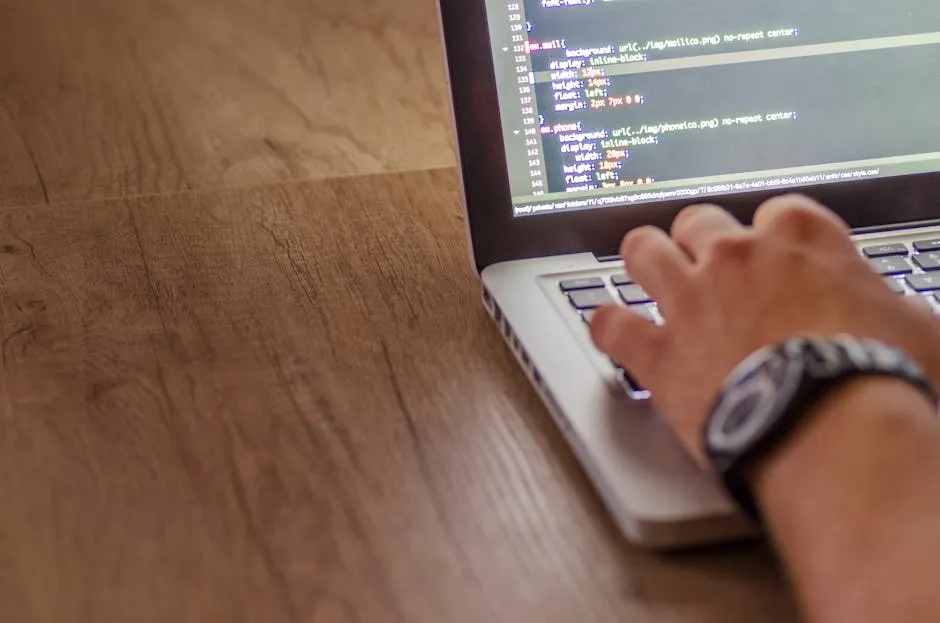 Close-up of a person coding on a laptop, showcasing web development and programming concepts. — Photo by Lukas Blazek on Pexels