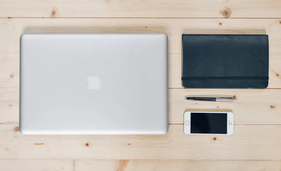 A clean, organized desk featuring a laptop, smartphone, notebook, and pen, ideal for productivity. — Photo by Pixabay on Pexels