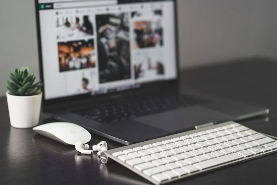 A sleek modern workspace featuring a laptop, keyboard, mouse, AirPods, and a small plant. — Photo by Jean-Daniel Francoeur on Pexels