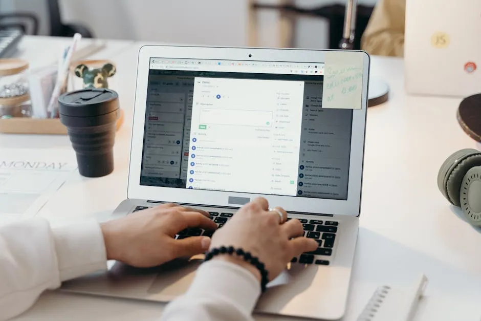 A person typing on a laptop in a bright, modern office setting, showing productivity and technology. — Photo by cottonbro studio on Pexels
