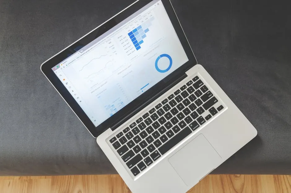 Overhead view of a laptop showing data visualizations and charts on its screen. — Photo by Lukas Blazek on Pexels