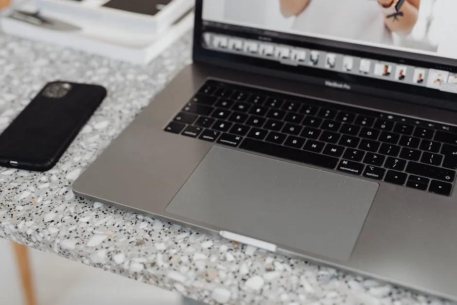 Close-up of a laptop and smartphone on a terrazzo surface, showcasing modern workspace essentials. — Photo by www.kaboompics.com on Pexels