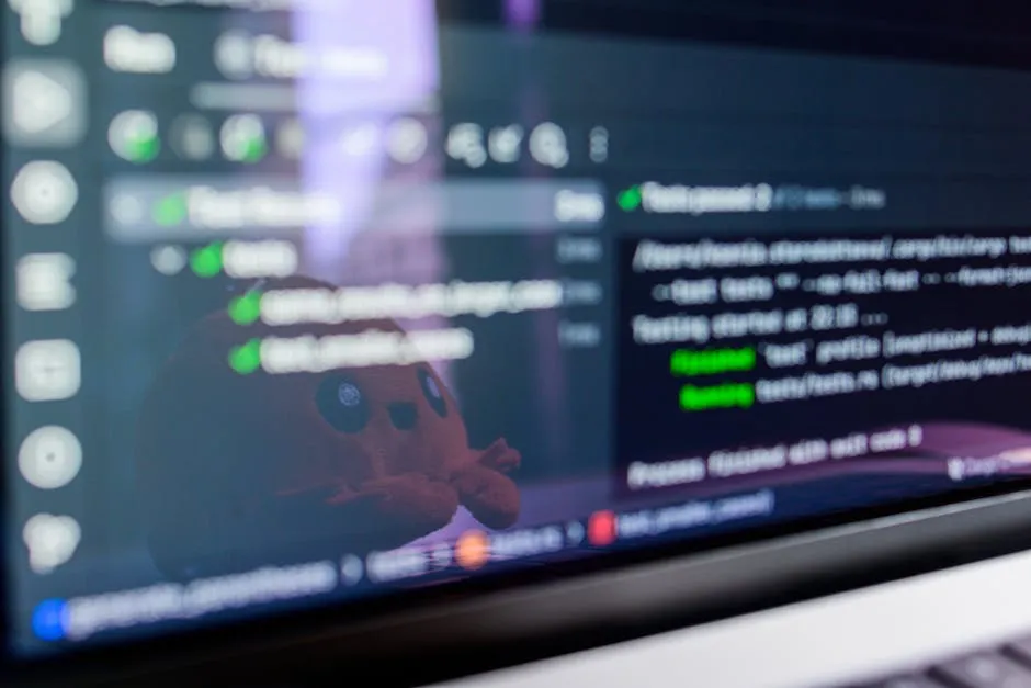 Close-up of a laptop screen displaying programming code with a cute plush toy reflecting. — Photo by Daniil Komov on Pexels