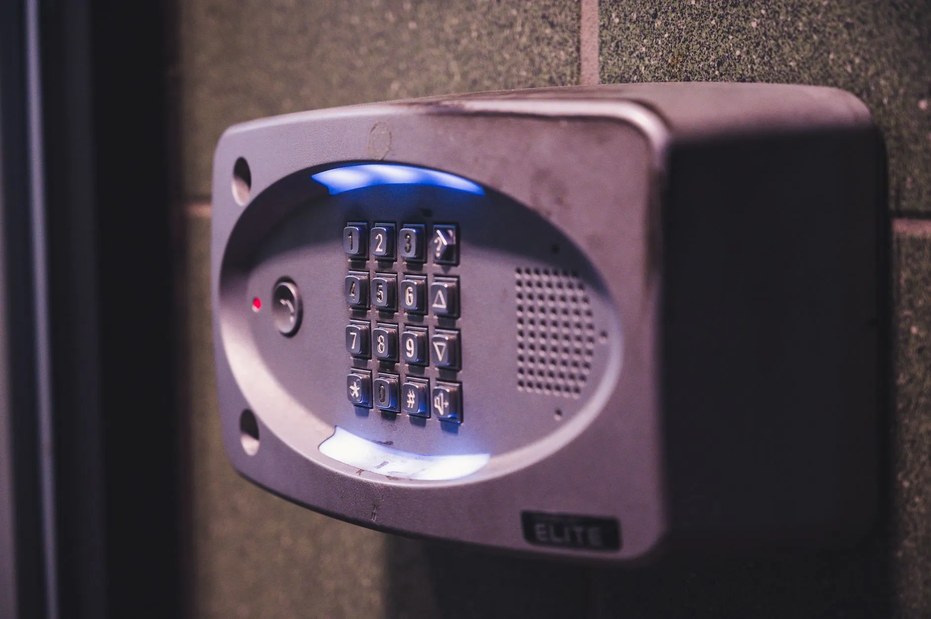 Illuminated security keypad on a wall representing password protection